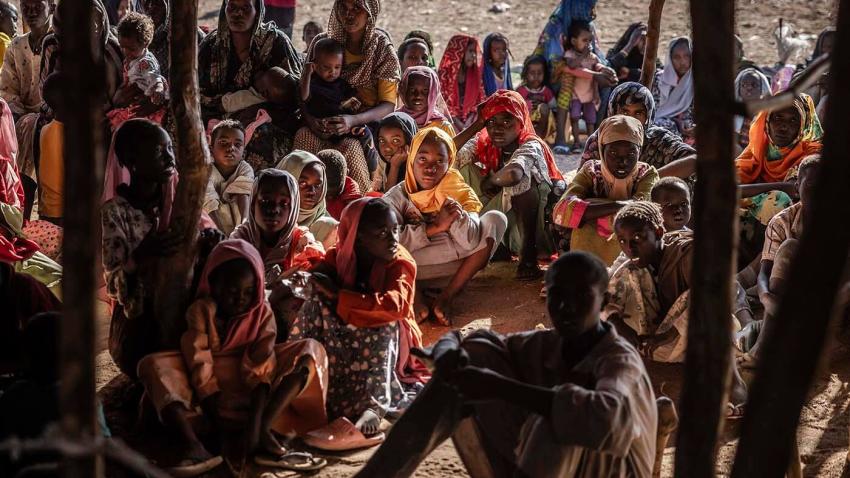 Sudanese refugees and ethnic South Sudanese families who have fled from the war in Sudan gather after crossing the border while waiting to be registered by the authorities at the Joda Border Crossing 