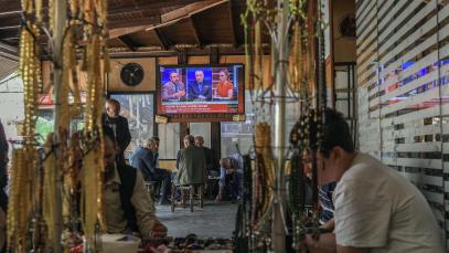 This photograph shows a screen announcing of PKK's (Kurdish Workers Party) dissolution on the News on a television screen inside a traditional Turkish tea house, in Diyarbakir, on May 12, 2025. 